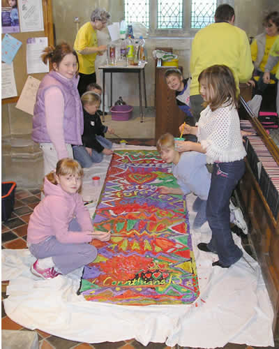 PHOTO: Sparks working on a giant banner declaring that God's love is forever (Corinthians)