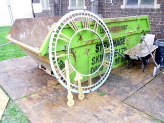 Propped up against the skip, the clock face reveals it's true size